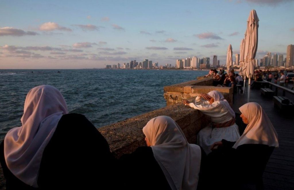 Femmes arabes regardnant le soleil couchant dans la ville Israelienne de Jaffa